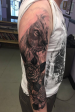 In Progress black and grey realistic Lion and rose sleeve.
